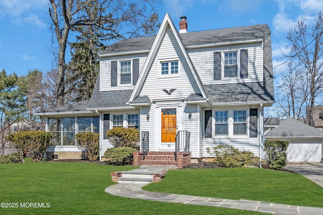 view of front of home featuring a chimney, a shingled roof, a front yard, and a sunroom