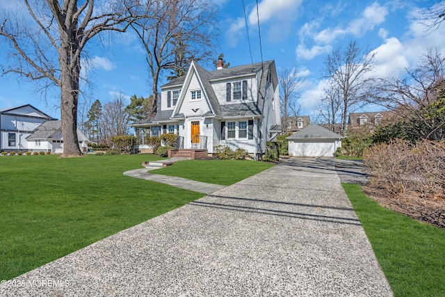 shingle-style home with a shingled roof, a chimney, an outdoor structure, a front lawn, and a garage