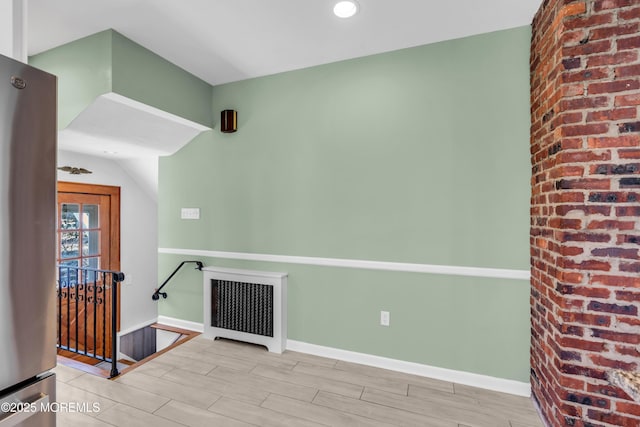 unfurnished room featuring wood finish floors and baseboards