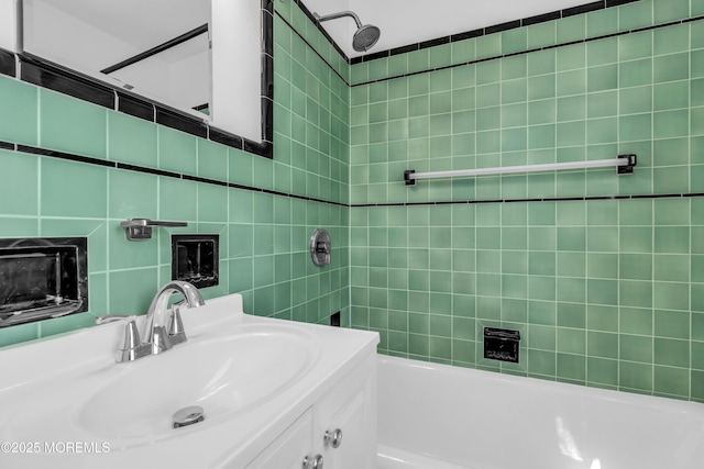 full bathroom featuring tub / shower combination, tile walls, and vanity