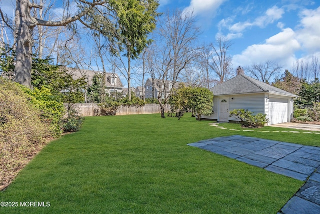 view of yard featuring an outdoor structure and fence