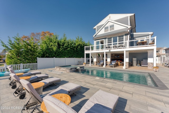 view of swimming pool with a patio area, an outdoor hangout area, a pool with connected hot tub, and fence