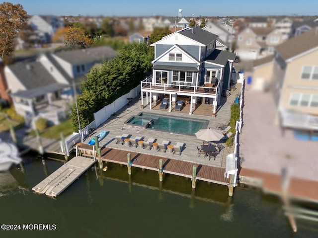 back of property featuring a patio area, a fenced in pool, a fenced backyard, and a deck with water view