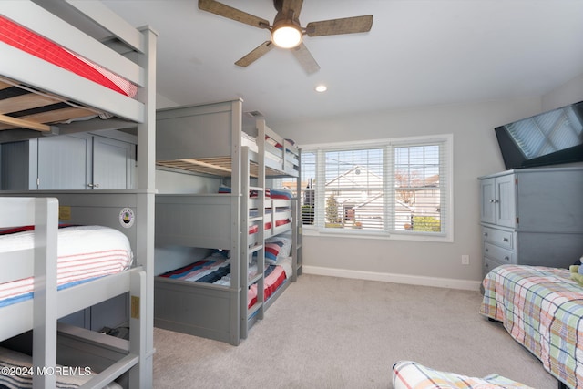 bedroom with recessed lighting, light colored carpet, a ceiling fan, and baseboards