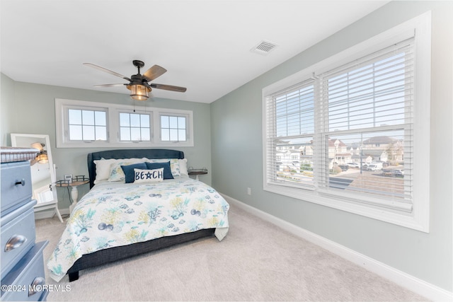 bedroom with a ceiling fan, carpet, visible vents, and baseboards