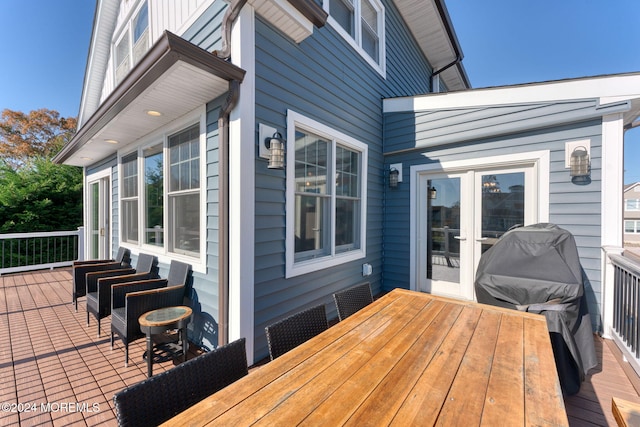 deck featuring french doors and a grill