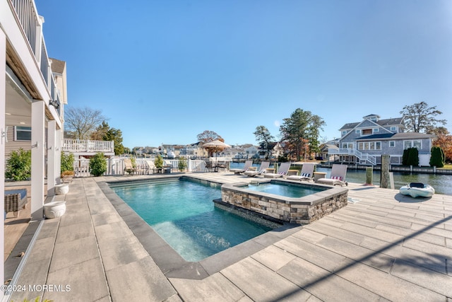 view of pool with a patio area and a pool with connected hot tub