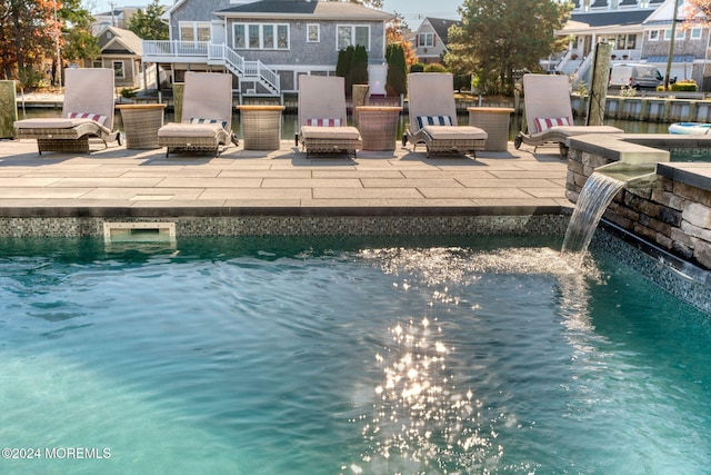 view of swimming pool with a patio area, a residential view, and stairs