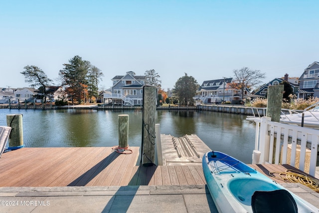 view of dock featuring a residential view and a water view