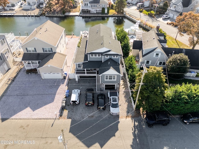 drone / aerial view with a residential view and a water view