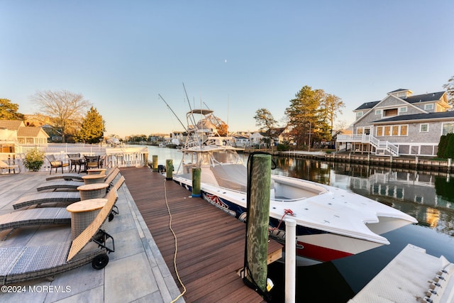 view of dock featuring a water view and a residential view