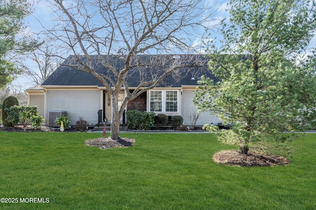 view of front facade with central AC unit and a front yard