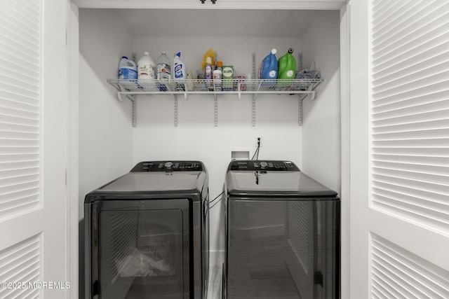 washroom featuring laundry area and washing machine and dryer