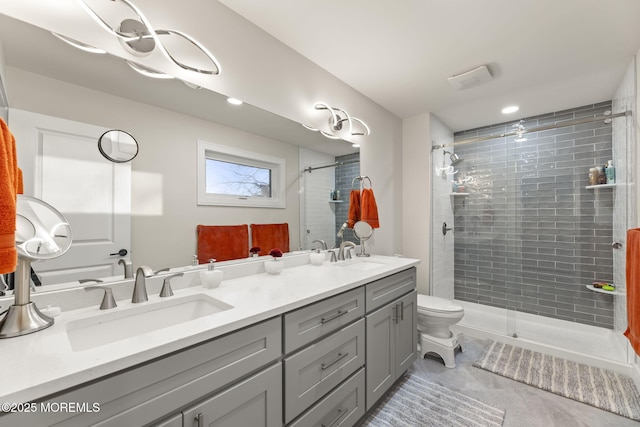 bathroom with double vanity, a stall shower, and a sink