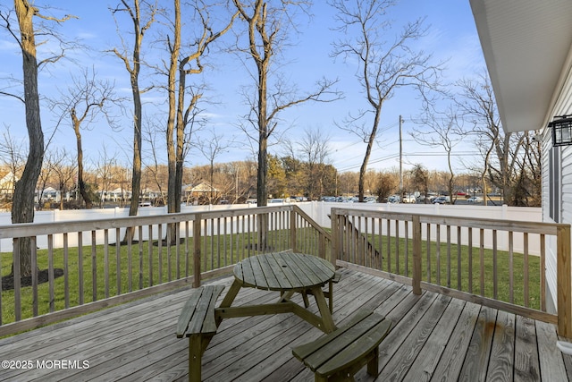 deck with a yard and fence