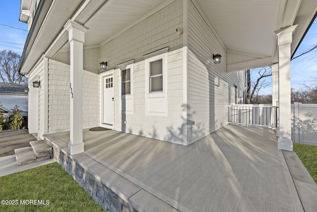 property entrance with a water view and a porch