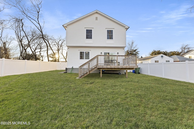 rear view of property featuring a deck, stairway, a yard, and a fenced backyard