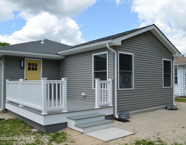 71 Montserrat St, Toms River, NJ 08757 - rear view of property with a shingled roof and a deck