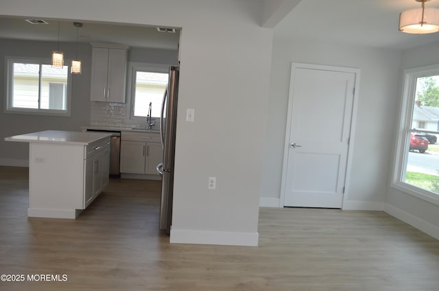 71 Montserrat St, Toms River, NJ 08757 - kitchen with stainless steel appliances, baseboards, a sink, light wood-style floors, and healthy amount of natural light