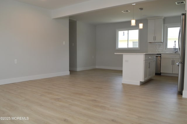 71 Montserrat St, Toms River, NJ 08757 - kitchen with stainless steel dishwasher, light countertops, plenty of natural light, and baseboards