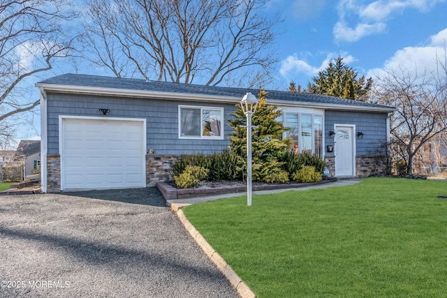 ranch-style home with a shingled roof, aphalt driveway, a front yard, a garage, and stone siding