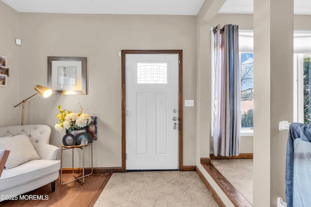 entryway featuring baseboards and wood finished floors