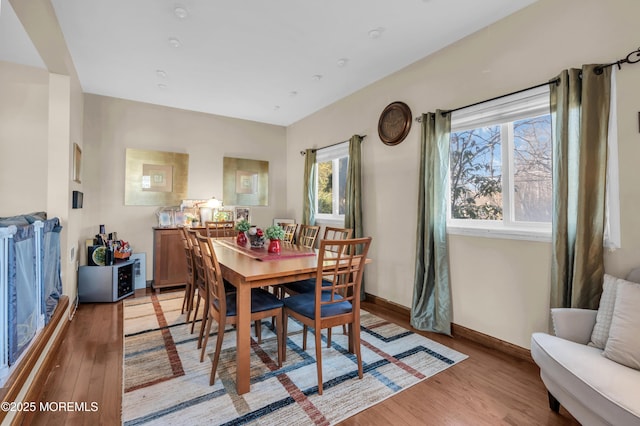 dining area with baseboards and light wood-type flooring