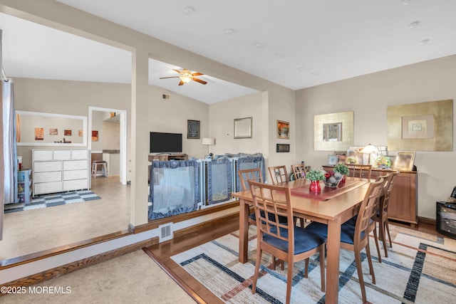 dining space featuring visible vents, a ceiling fan, and lofted ceiling