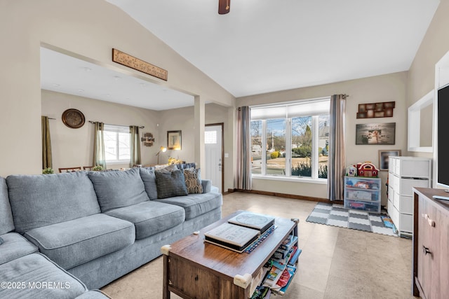 living room featuring baseboards and lofted ceiling