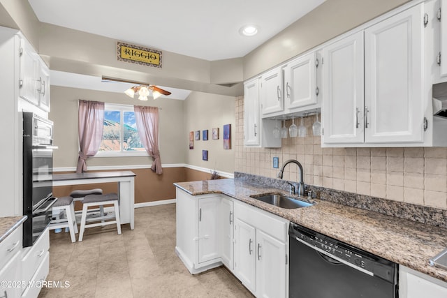 kitchen with oven, a sink, a peninsula, white cabinets, and dishwasher