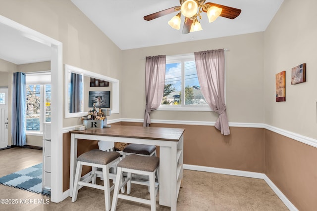 dining room with baseboards, plenty of natural light, and ceiling fan