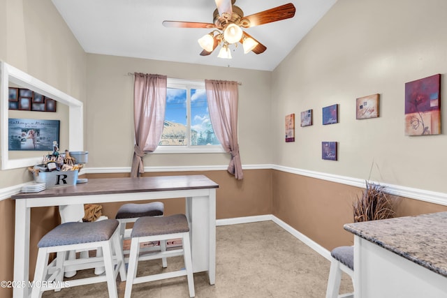 office with ceiling fan, baseboards, and vaulted ceiling