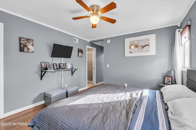 bedroom with visible vents, ceiling fan, baseboards, ornamental molding, and wood finished floors