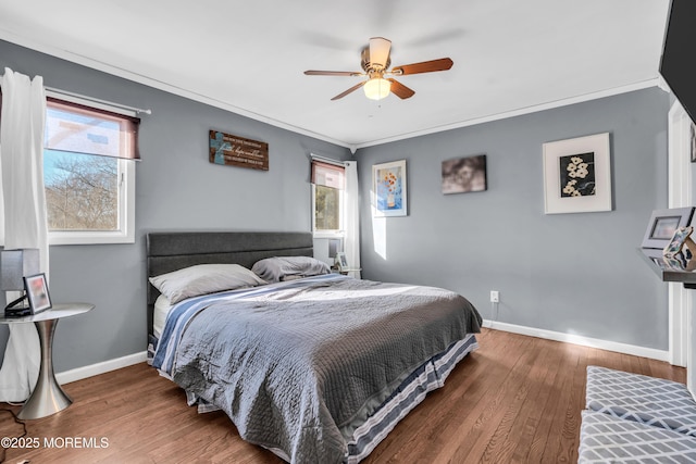 bedroom featuring baseboards, multiple windows, and wood finished floors