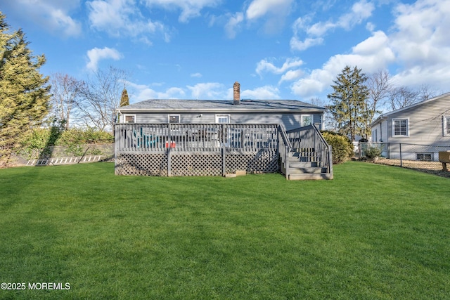 back of house with a yard, a deck, a chimney, and fence