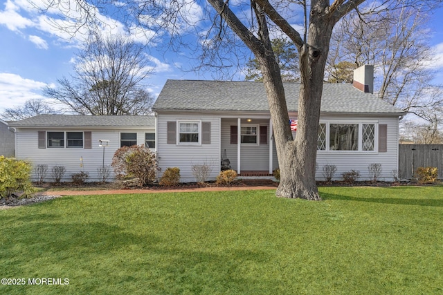 single story home featuring a front yard, fence, roof with shingles, and a chimney