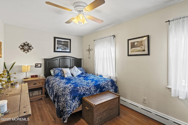 bedroom with a baseboard heating unit, wood finished floors, and a ceiling fan