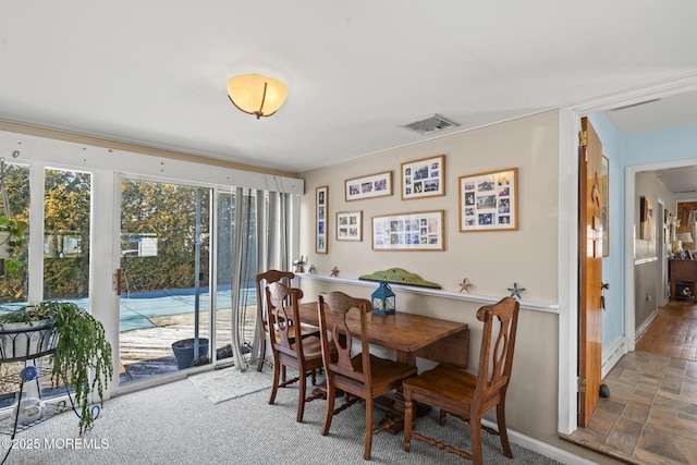 dining area featuring baseboards and visible vents