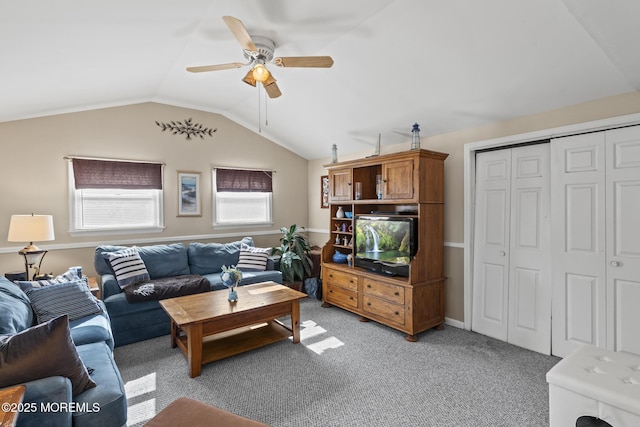 living area with light carpet, ceiling fan, and lofted ceiling