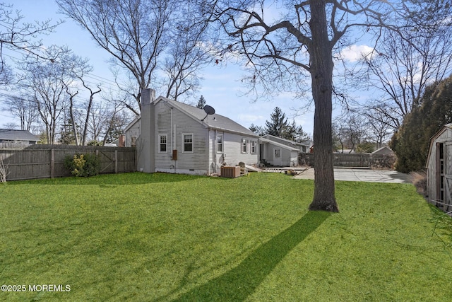 view of yard featuring a patio area, a fenced backyard, and central AC