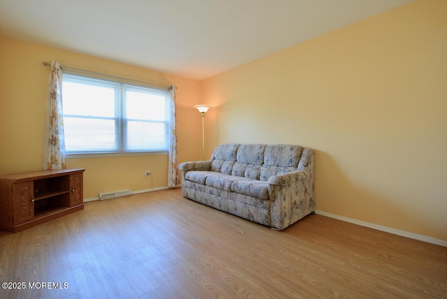 sitting room featuring wood finished floors, visible vents, and baseboards