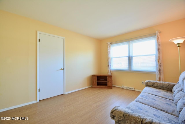 living area featuring visible vents, baseboards, and wood finished floors