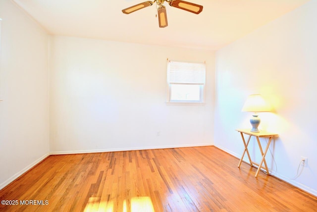 unfurnished room with wood finished floors, baseboards, and ceiling fan