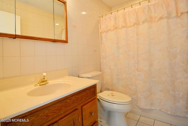 bathroom with vanity, tile patterned flooring, tile walls, toilet, and tasteful backsplash