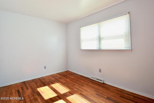 empty room with visible vents, baseboards, and wood finished floors