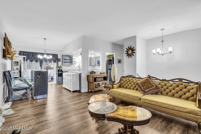 living area with an inviting chandelier and dark wood-style flooring