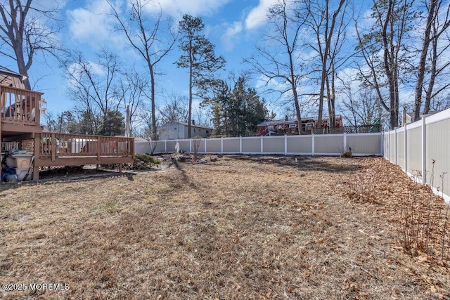 view of yard featuring a wooden deck and a fenced backyard