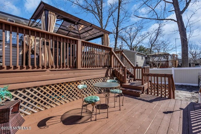 wooden terrace featuring fence