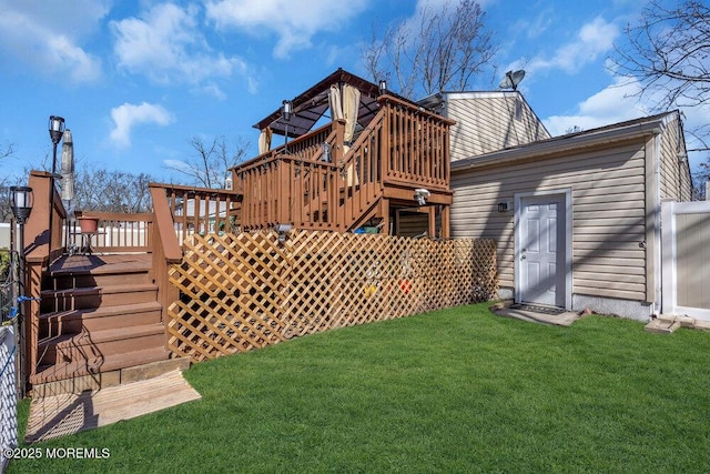 back of house with stairway, a lawn, and a deck