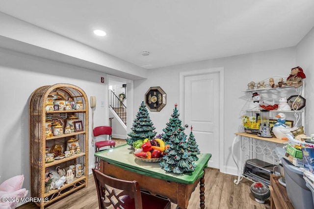 dining space featuring recessed lighting, stairway, and wood finished floors